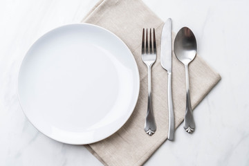 empty plate spoon fork and knife