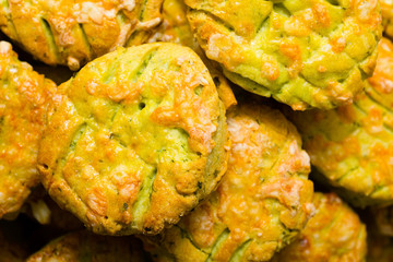 homemade baked scone cakes from fresh ramson leaves and cheese, old wooden texture