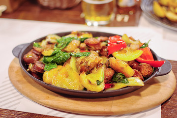 Freshly cooked one pot sausage and vegetables served in frying pan