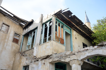 Fototapeta na wymiar Destroyed house with broken windows on Turkish side of Nicosia, Cyprus