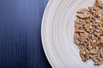 Walnuts on the wooden plate on the table