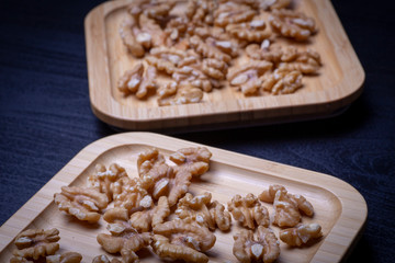 Walnuts on the wooden plate on the table