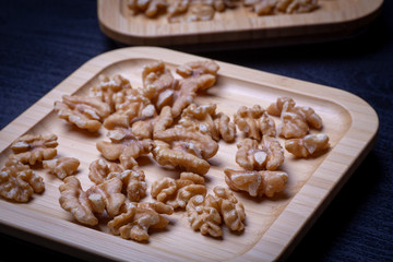 Walnuts on the wooden plate on the table