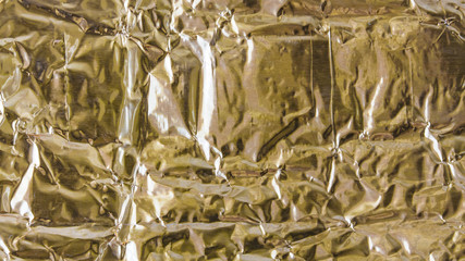 Gold Paper creased and folded to provide a textured background