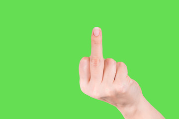 Angry rude woman shows one middle finger into camera. Female hand flipping off isolated at green chromakey background. Fingernail with beautiful pink manicure. Horizontal color photography.