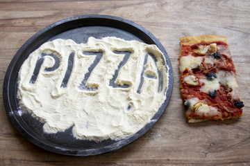 pizza word written on the flour