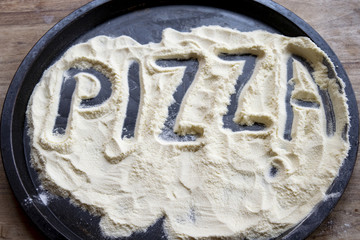pizza word written on the flour