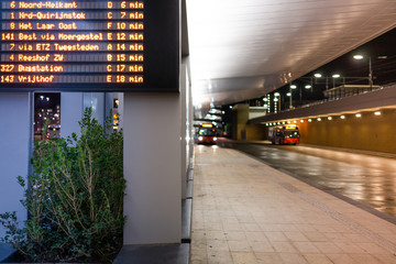 An information sign with bus departure times on the train station in Tilburg, Noord Brabant, Netherlands.