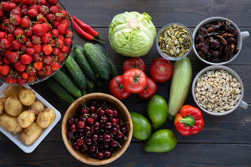 Healthy food. Fish, meat and vegetables. On a dark wooden background. Top view.