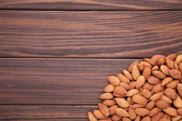 Group of almonds on a brown background