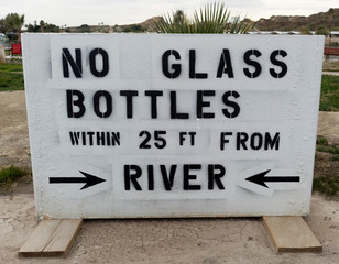 NO GLASS BOTTLES sign at Colorado River.