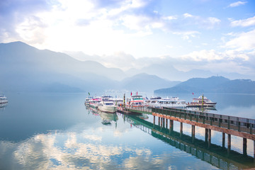 boat and speed boat pier in sunrise morning at Sun moon lake , taiwan - 259909811