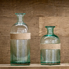 two decoration bottles in front of antique oak wood structure