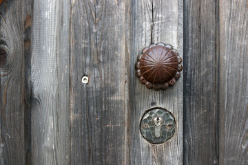 The Modern wooden door with metal door handle over the white wall. -Image