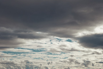 layers of grey and white clouds over blue sky