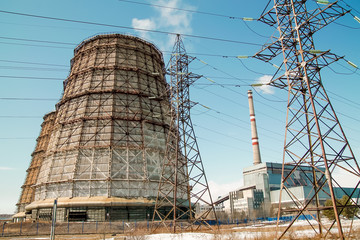 Cooling tower of a power plant with blue sky on the background