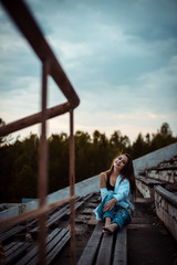 woman sitting dreaming and relaxing. Sunset. Summer. Outdoor