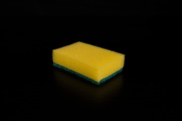 Yellow sponge on black background. Isolated
