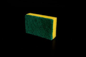 Yellow sponge on black background. Isolated