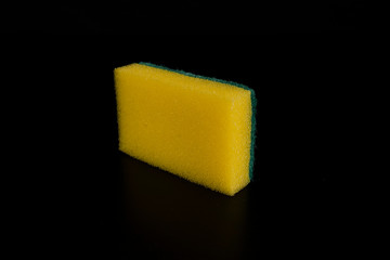 Yellow sponge on black background. Isolated