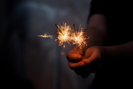 Woman hand holding a burning sparkler