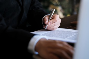 man signing a contract