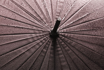 Closeup of umbrella texture in raindrops
