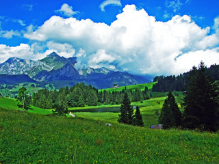 Beautiful clouds above the alpine mountain massif Alpstein and the Thur River valley - Canton of...
