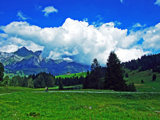 Beautiful clouds above the alpine mountain massif Alpstein and the Thur River valley - Canton of...