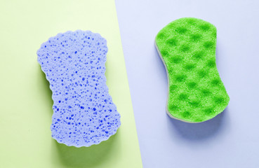 Two abrasive double-sided sponges on  pastel background. Minimalism, top view
