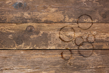 Trail from cups of coffee on old wooden background. Top view. Flat lay.