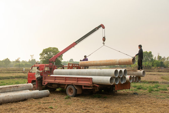 Nakhon Phanom, Thailand. March 4, 2019 : Concrete pipes loading with crane truck