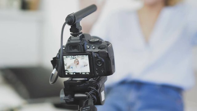 Popular female blogger is turning on the camera and strating recording video