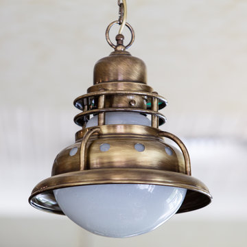 vintage bronze chandelier suspended from the ceiling by a metal chain