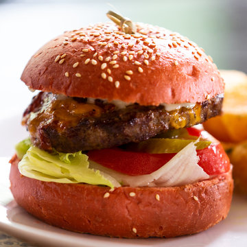 meat burger with onion tomato lettuce and pickled cucumber