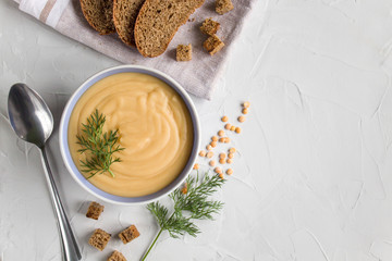 pea cream soup with croutons on a light background. The view from the top . Copy space