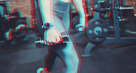 Training concept. Glitch effect. Closeup of tense leg muscles in leggings.Fitness woman with sports body exercising with dumbbells in the gym. Lunges with dumbbells.