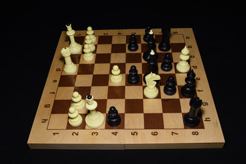 Wooden chessboard and white pieces as a hobby concept