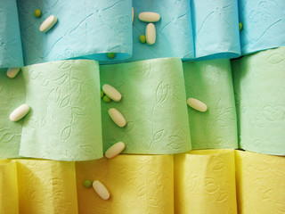 Colored toilet paper and pills on it