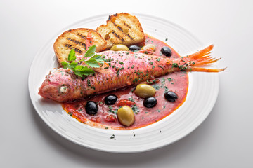 Dish with mullet fish tomato and parsley