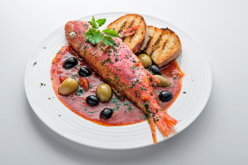 Dish with mullet fish tomato and parsley