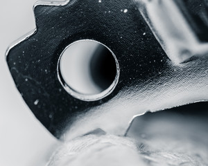 Black and white detailed macro abstract of bottle opener posed in position to open