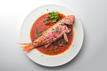 Dish with mullet fish tomato and parsley