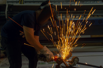 Electric wheel grinding cuting on steel. sparks from cutting