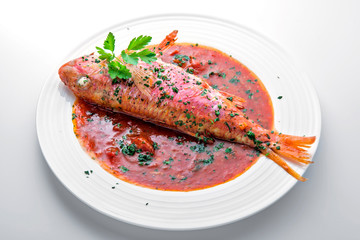 Dish with mullet fish tomato and parsley
