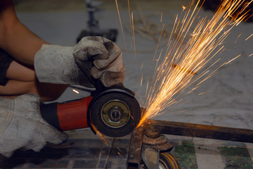 Electric wheel grinding cuting on steel. sparks from cutting