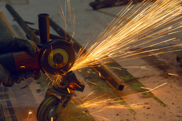 Electric wheel grinding cuting on steel. sparks from cutting