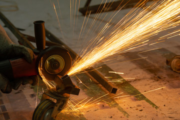 Electric wheel grinding cuting on steel. sparks from cutting