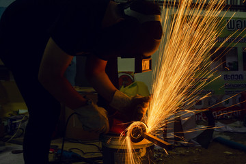 Electric wheel grinding cuting on steel. sparks from cutting