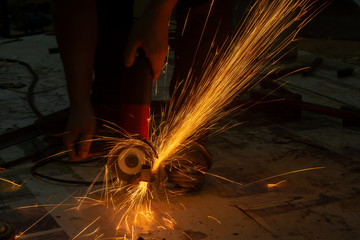 Electric wheel grinding cuting on steel. sparks from cutting